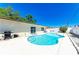 Backyard view showcasing the sparkling in-ground pool with a patio area, perfect for outdoor entertainment at 507 Shore Dr, Largo, FL 33771
