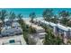 Aerial view of beachfront condos featuring mature trees, near the ocean, and close to community tennis courts at 5125 Gulf Of Mexico Dr # 4, Longboat Key, FL 34228