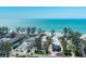 Aerial view of a property with landscaping, a tennis court, and beachfront access at 5125 Gulf Of Mexico Dr # 4, Longboat Key, FL 34228