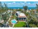 Aerial view of property shows a private pool, manicured lawn, and balcony overlooking tropical landscaping and ocean views at 5125 Gulf Of Mexico Dr # 4, Longboat Key, FL 34228