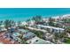 Gorgeous coastal aerial view of beachfront condos, community tennis court, and turquoise Gulf waters at 5125 Gulf Of Mexico Dr # 4, Longboat Key, FL 34228