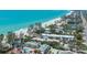 Beautiful aerial view showcases beachfront condos, framed by mature trees, directly on the Gulf of Mexico at 5125 Gulf Of Mexico Dr # 4, Longboat Key, FL 34228