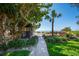 Beautiful backyard with gazebo and walkway leading to beach access and lounge chairs at 5125 Gulf Of Mexico Dr # 4, Longboat Key, FL 34228