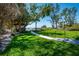 Lush backyard with well-maintained lawn and walkway to the beach at 5125 Gulf Of Mexico Dr # 4, Longboat Key, FL 34228