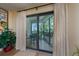 Covered balcony with sliding glass doors that open to seating and beautiful landscaping at 5125 Gulf Of Mexico Dr # 4, Longboat Key, FL 34228