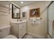 Bathroom with modern sink, toilet, and decorative mirror and artwork at 5125 Gulf Of Mexico Dr # 4, Longboat Key, FL 34228