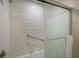 Bathroom featuring a white tiled shower with updated shower door and fixtures at 5125 Gulf Of Mexico Dr # 4, Longboat Key, FL 34228