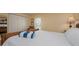 Bright bedroom featuring white linens and shutters for natural light and privacy at 5125 Gulf Of Mexico Dr # 4, Longboat Key, FL 34228