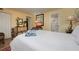 Bright bedroom featuring a large bed, a TV and a dresser, next to an en suite bathroom at 5125 Gulf Of Mexico Dr # 4, Longboat Key, FL 34228