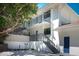 Modern building exterior with multiple stories, stairs and balcony at 5125 Gulf Of Mexico Dr # 4, Longboat Key, FL 34228