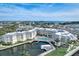 Beautiful aerial view of the resort-style condo complex with water access, a pool, and stunning views at 5325 Marina Drive # 423, Holmes Beach, FL 34217