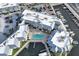 Aerial view showcasing the pool and courtyard area for waterfront complex with docks for boating at 5325 Marina Drive # 423, Holmes Beach, FL 34217