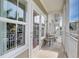 Outdoor balcony area with seating, bright light, and a view of surrounding area at 5325 Marina Drive # 423, Holmes Beach, FL 34217