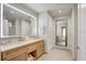 Bright bathroom featuring a double sink vanity, a mirror, and access to the shower at 5325 Marina Drive # 423, Holmes Beach, FL 34217