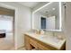Bathroom featuring a double sink vanity and a mirror, with a partial view of the shower at 5325 Marina Drive # 423, Holmes Beach, FL 34217