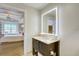 Bathroom with a well-lit mirror over the vanity with an open view into the bedroom at 5325 Marina Drive # 423, Holmes Beach, FL 34217