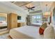 Bright bedroom featuring a decorative ceiling, ceiling fan, two beds and a window view at 5325 Marina Drive # 423, Holmes Beach, FL 34217