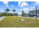 Scenic waterfront view with palm trees, grassy area, and boat dock, perfect for enjoying coastal living at 5325 Marina Drive # 423, Holmes Beach, FL 34217