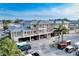Exterior shot of multi-level building with balconies, covered parking, and lush palm trees at 5325 Marina Drive # 423, Holmes Beach, FL 34217