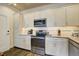 Modern, all-white kitchen featuring stainless steel appliances, sleek counters, and stylish hardware at 5325 Marina Drive # 423, Holmes Beach, FL 34217