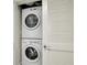 Stacked washer and dryer inside a laundry closet with white louvered doors at 5325 Marina Drive # 423, Holmes Beach, FL 34217