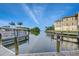 Picturesque view of boat docked near condo building, with waterway, perfect for island tours at 5325 Marina Drive # 423, Holmes Beach, FL 34217