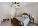 Inviting bedroom with a wood-framed bed, ceiling fan, and plenty of natural light at 5442 Kent Rd, Venice, FL 34293