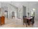 Open-plan dining room featuring tile flooring, archway entry, high ceilings and natural light from the front door at 5442 Kent Rd, Venice, FL 34293