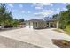 Spacious driveway and multiple garages, with additional covered parking, offering ample room for vehicles and convenience at 5442 Kent Rd, Venice, FL 34293