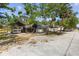 View of the garage and attached carports set on a sprawling lot in a quiet rural setting at 5442 Kent Rd, Venice, FL 34293