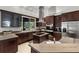 Modern kitchen with a cooktop island, stainless steel appliances, custom cabinetry, and granite countertops at 5442 Kent Rd, Venice, FL 34293