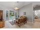 Bright living room with tile flooring and sliding glass doors to the pool area at 5442 Kent Rd, Venice, FL 34293