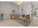 Bright living room featuring high ceilings, neutral decor, and tile flooring, open to a dining area at 5442 Kent Rd, Venice, FL 34293