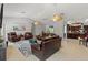 Open-concept living room with hardwood flooring and abundant seating, adjacent to kitchen at 5442 Kent Rd, Venice, FL 34293
