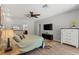Comfortable bedroom featuring wood-look flooring, ceiling fan, and an ensuite bathroom at 5442 Kent Rd, Venice, FL 34293