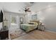 Comfortable bedroom with wood-look flooring, neutral walls, and view of the screened pool at 5442 Kent Rd, Venice, FL 34293