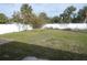 Beautiful backyard showcasing the lush green grass and white privacy fence at 5578 Thyer St, North Port, FL 34288