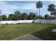 Expansive backyard featuring lush green grass and a tall, white privacy fence at 5578 Thyer St, North Port, FL 34288