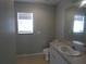 Bathroom featuring a vanity with a sink, toilet, and a window for natural light at 5578 Thyer St, North Port, FL 34288