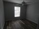 This bedroom features a large, light-filled window and beautiful wood-look floors at 5578 Thyer St, North Port, FL 34288