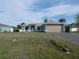 Picture of a one-story home featuring a spacious front yard, well-kept lawn, and a two-car garage at 5578 Thyer St, North Port, FL 34288