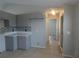 Neutral kitchen features tiled floors, gray cabinets and a backsplash at 5578 Thyer St, North Port, FL 34288