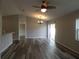 Inviting living room featuring hardwood floors, a ceiling fan, chandelier, and backyard access at 5578 Thyer St, North Port, FL 34288
