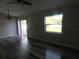 Bright and spacious living room showcasing beautiful floors, ceiling fan, and a sliding door to the backyard at 5578 Thyer St, North Port, FL 34288