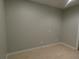 Neutral room featuring tiled flooring, gray walls, and minimal lighting at 5578 Thyer St, North Port, FL 34288