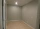 Neutral room featuring tiled flooring, gray walls, and minimal lighting at 5578 Thyer St, North Port, FL 34288