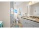 Bright bathroom featuring a shower with glass door and granite vanity at 5608 Holmes Blvd, Holmes Beach, FL 34217