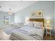 Comfortable bedroom featuring a queen bed, side tables, and a desk at 5608 Holmes Blvd, Holmes Beach, FL 34217