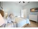 Comfortable bedroom with a queen bed, side tables, tv, and an open door at 5608 Holmes Blvd, Holmes Beach, FL 34217