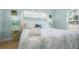 Light and airy bedroom featuring a queen bed, tropical decor and calming blue walls at 5608 Holmes Blvd, Holmes Beach, FL 34217